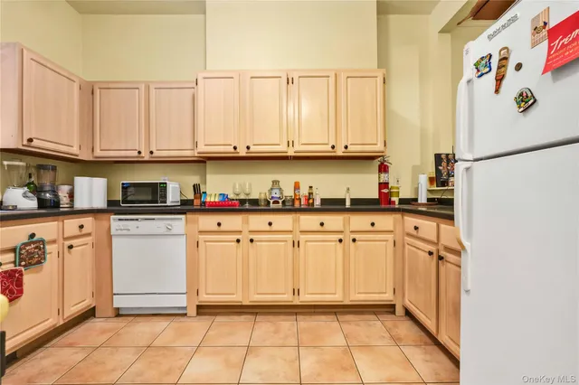 a kitchen with stainless steel appliances granite countertop a refrigerator sink and cabinets
