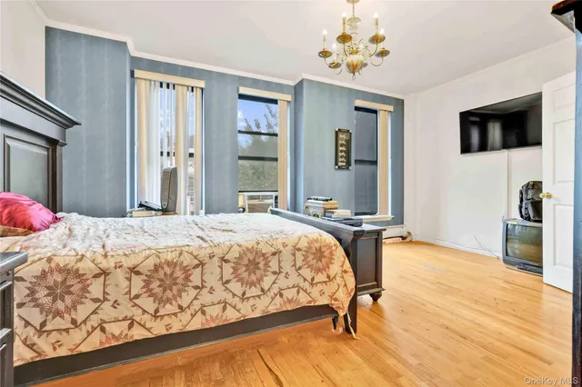 a bedroom with a bed dresser and a flat screen tv