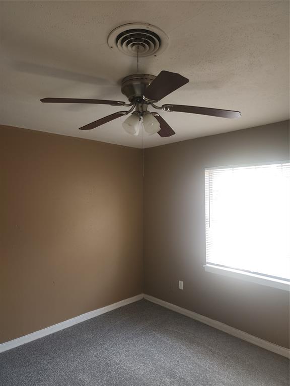 3454 Guadalupe Road Fort Worth, TX 76116 - Photo 13 of 21 Empty room with carpet, a ceiling fan, and a textured ceiling