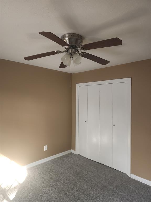 3454 Guadalupe Road Fort Worth, TX 76116 - Photo 14 of 21 Unfurnished bedroom with carpet, a ceiling fan, and a closet