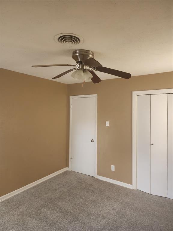 3454 Guadalupe Road Fort Worth, TX 76116 - Photo 16 of 21 Unfurnished bedroom with a closet, ceiling fan, and carpet flooring