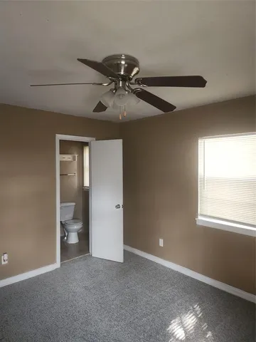 a view of a livingroom with a ceiling fan and window