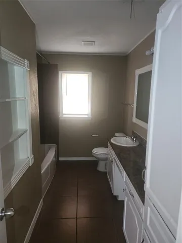 a bathroom with a granite countertop sink toilet and granite top