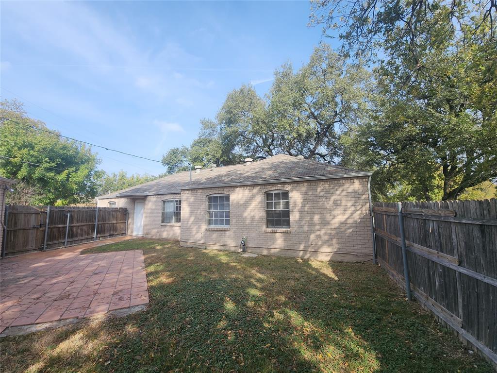 3454 Guadalupe Road Fort Worth, TX 76116 - Photo 21 of 21 Rear view of property featuring a patio, brick siding, and a fenced backyard