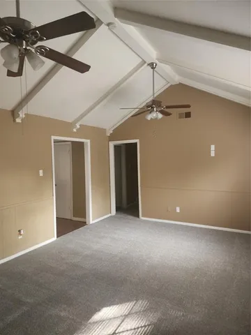 a view of a big room with a ceiling fan