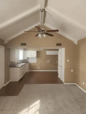 a view of a kitchen with a sink and cabinet