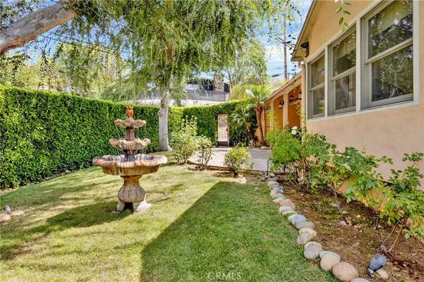 a view of a house with backyard and sitting area