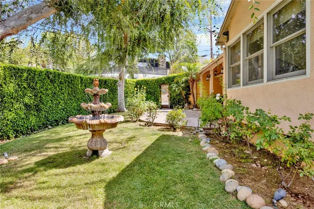 a view of a house with backyard and sitting area