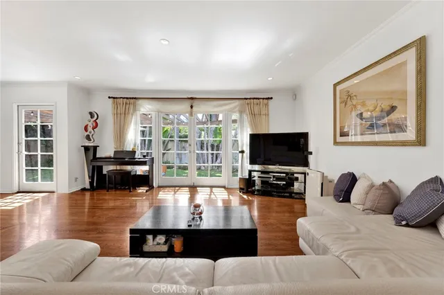 a living room with furniture large window and a flat screen tv