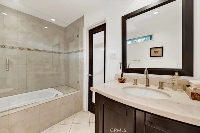 a bathroom with a granite countertop sink mirror toilet and bathtub