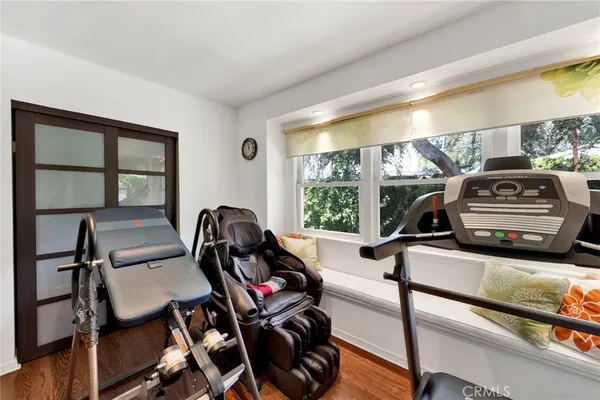 a view of a livingroom with furniture window and gym cycle