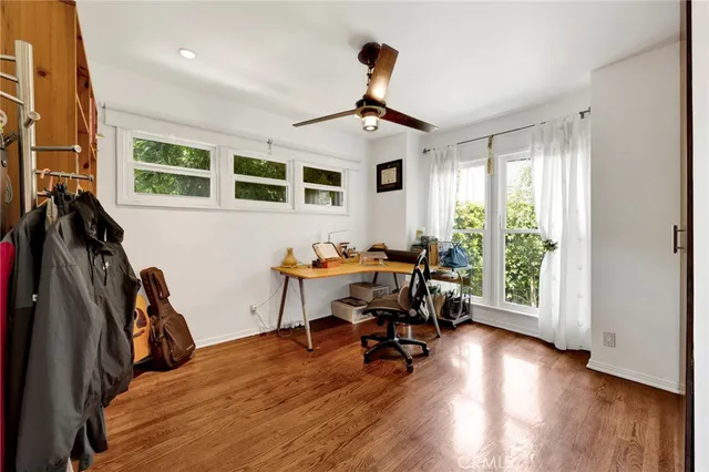 a view of a livingroom with workspace and a window