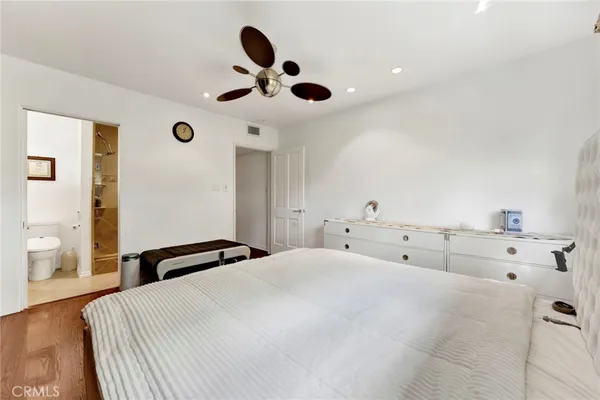 a bedroom with a bed and cabinets