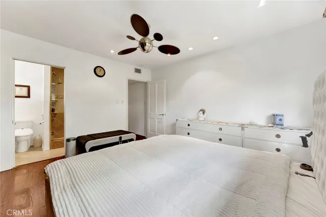 a bedroom with a bed and cabinets