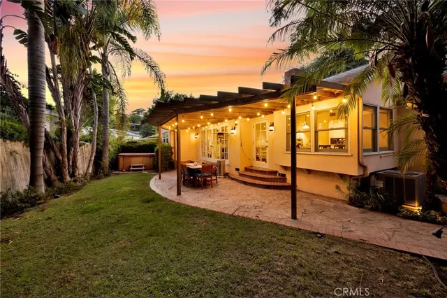 a view of swimming pool with a table and chairs under an umbrella
