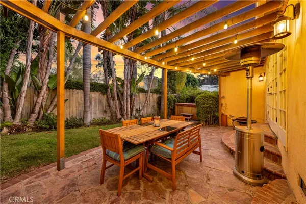 a patio with a yard table and chairs