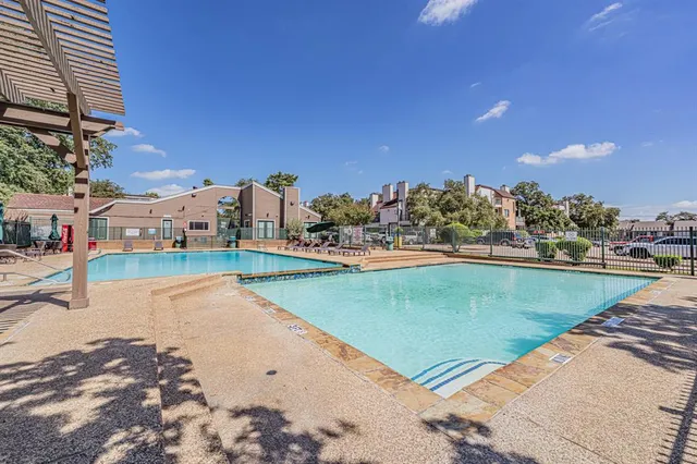 a view of a swimming pool and an outdoor seating