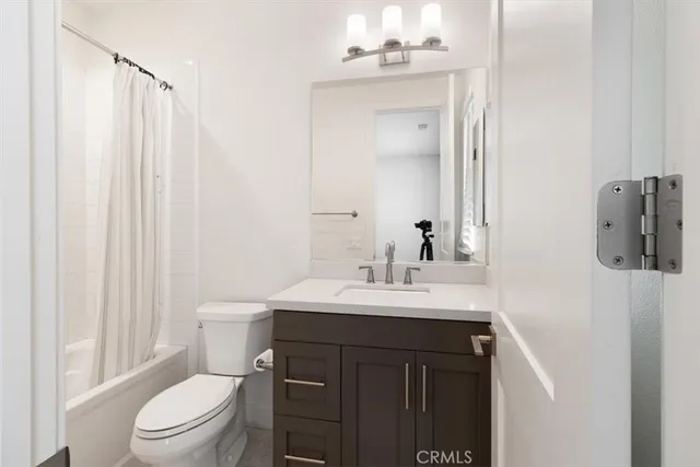 a bathroom with a toilet a sink and a mirror
