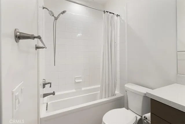 a bath room with a toilet and a bath tub
