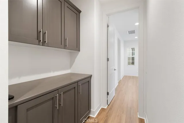 a view of a kitchen with wooden floor and cabinets