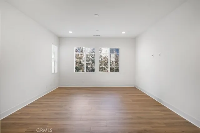 wooden floor in a hall with a window