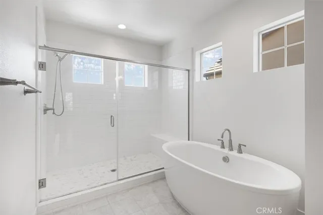 a bathroom with a bathtub and a shower