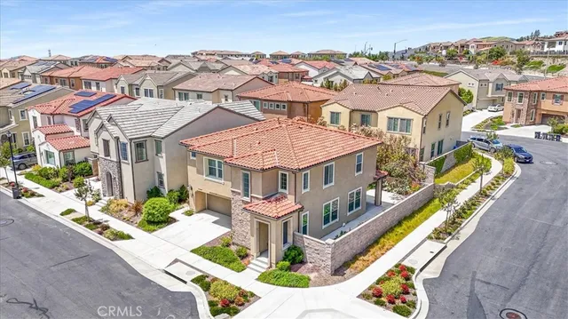 an aerial view of a house with a big yard