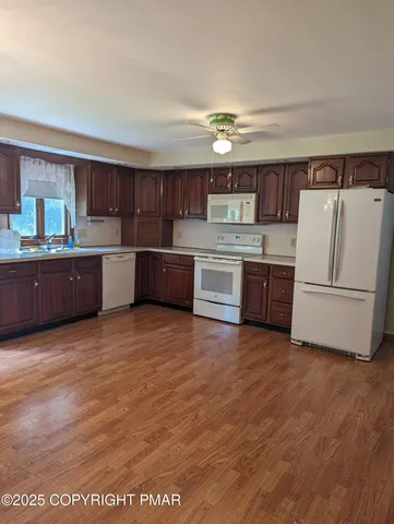 a view of kitchen and dining room with furniture window and outdoor view