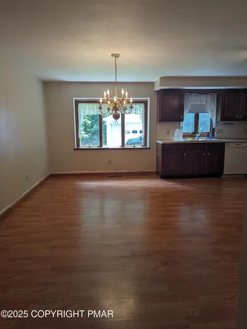 a kitchen with kitchen island a sink a stove and a chandelier