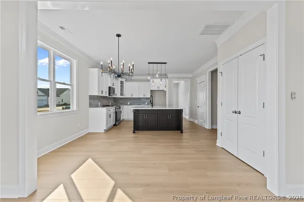 a view of a kitchen with kitchen island wooden floor and windows