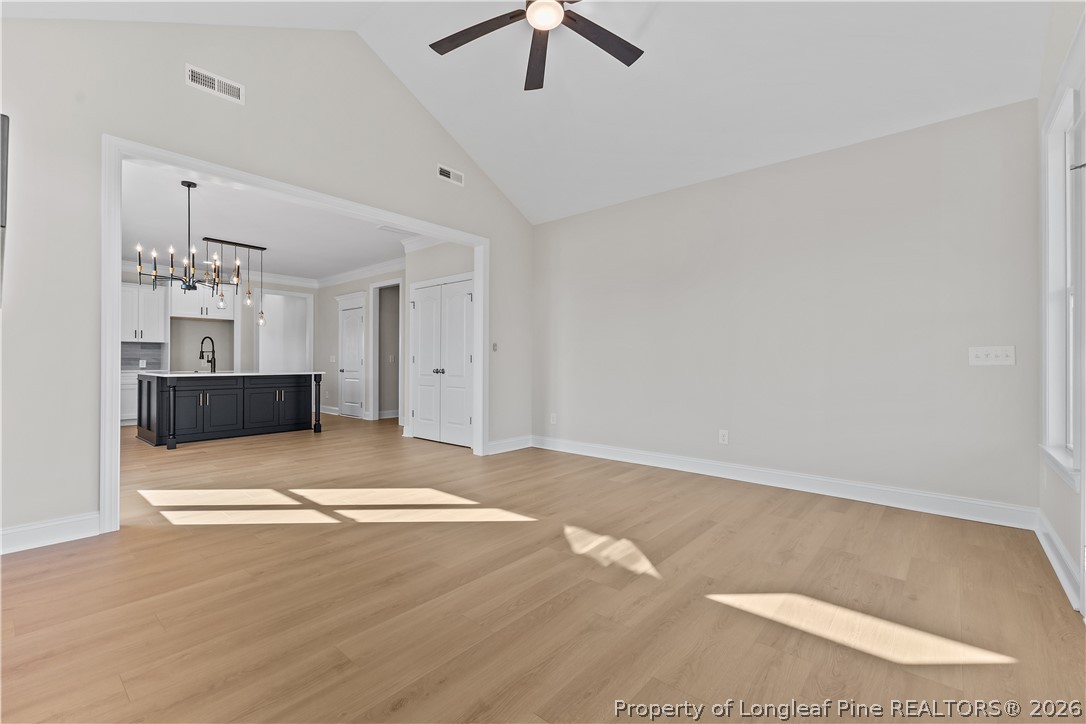 108 Sunny Acres Lane Clinton, NC 28328 - Photo 13 of 30 a view of livingroom with chandelier fan and kitchen view