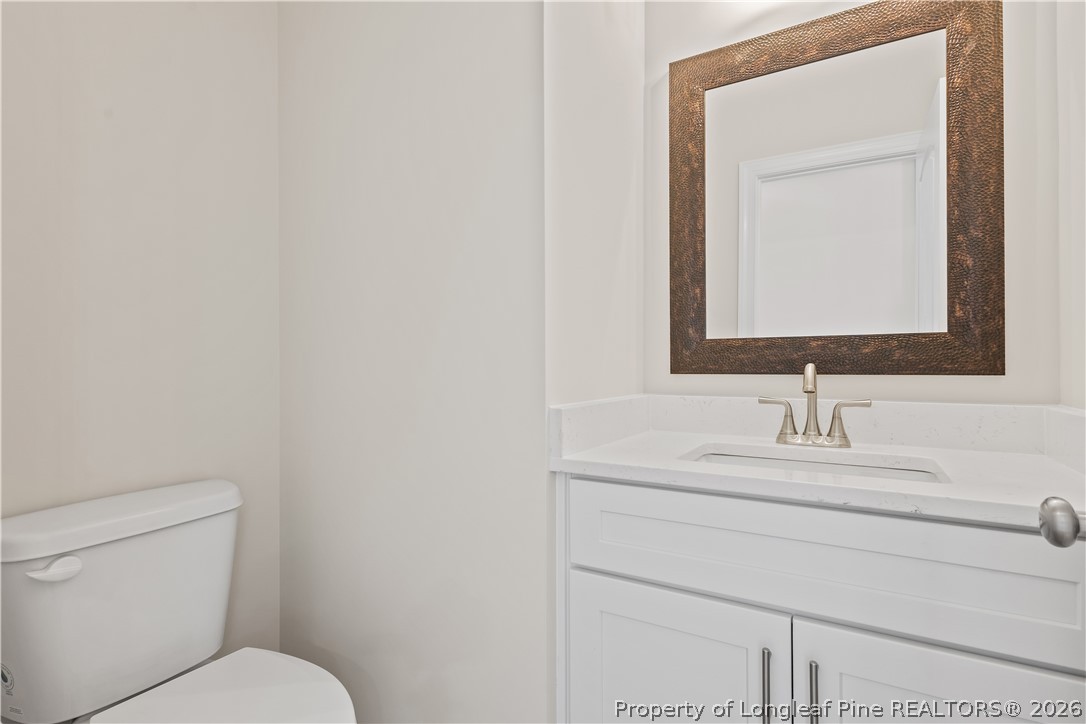 108 Sunny Acres Lane Clinton, NC 28328 - Photo 15 of 30 a bathroom with a toilet sink and mirror