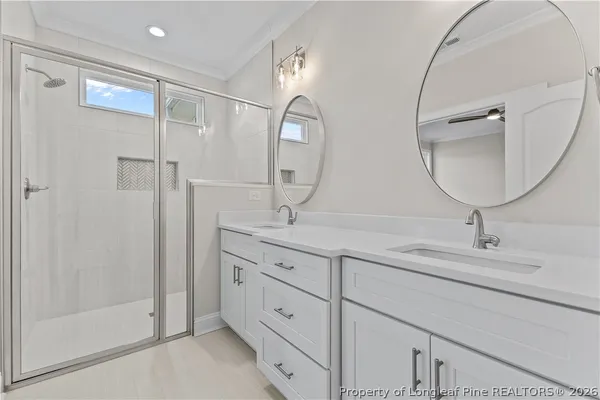 a bathroom with double vanity sink and a mirror