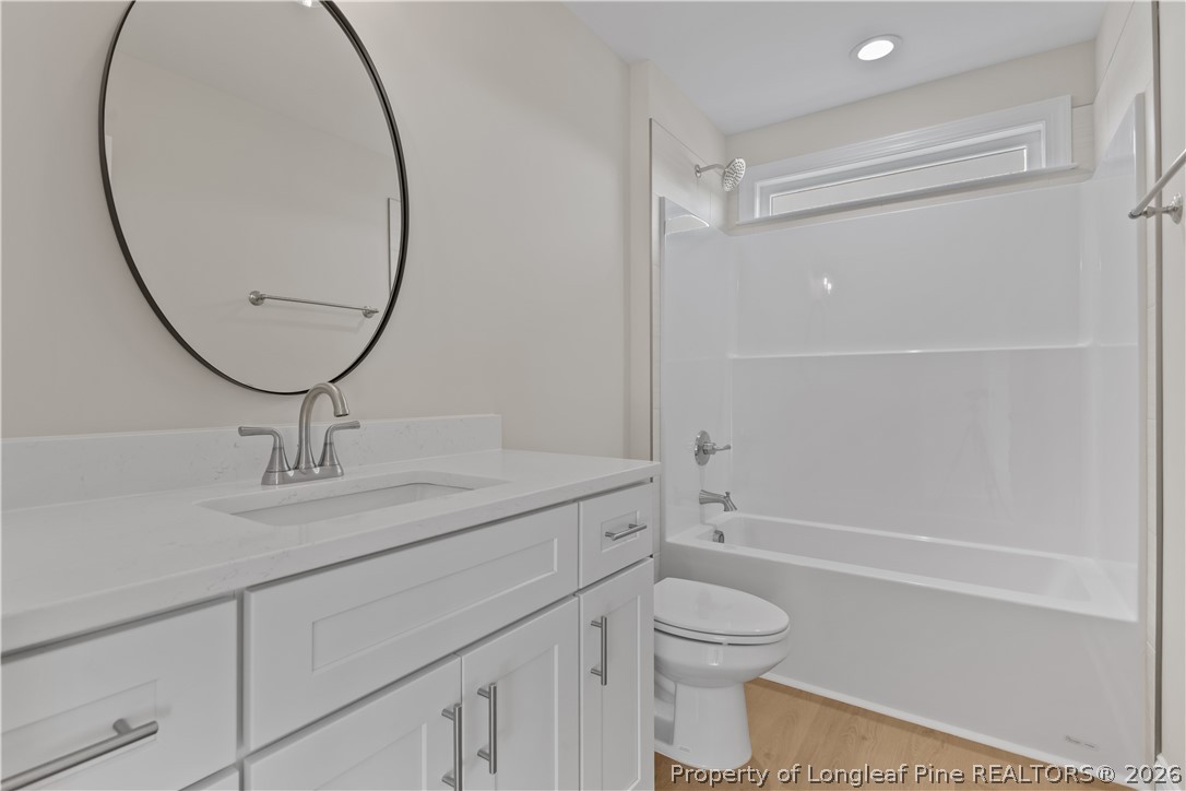 108 Sunny Acres Lane Clinton, NC 28328 - Photo 21 of 30 a bathroom with a granite countertop toilet a sink and a mirror