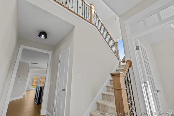 a view of entryway and hall with wooden floor
