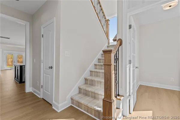 a view of entryway with wooden floor and stairs