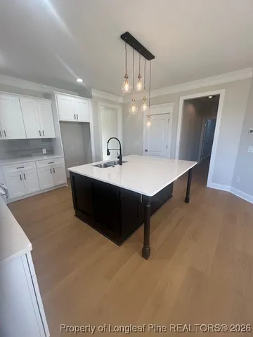 a large open kitchen with granite countertop a stove top oven a sink and dishwasher