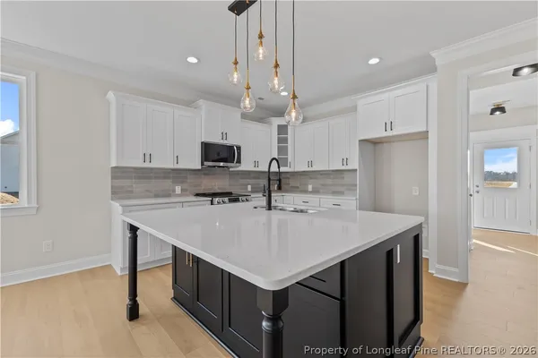 a kitchen with a sink a counter space cabinets and appliances