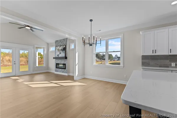 a view of an empty room with a window and fireplace