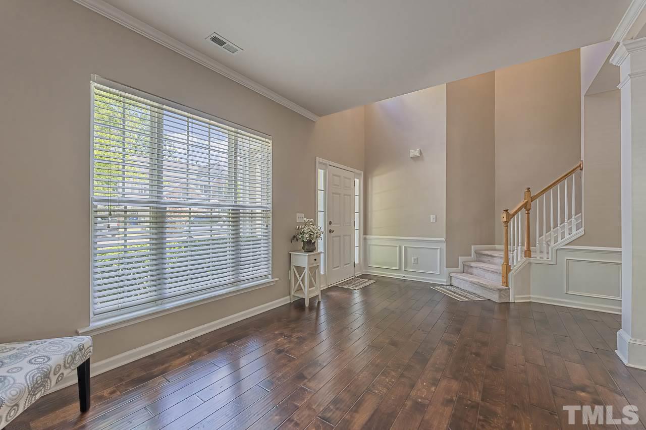 7759 San Gabriel Street Raleigh, NC 27613 - Photo 3 of 30 a view of an empty room with wooden floor and a window