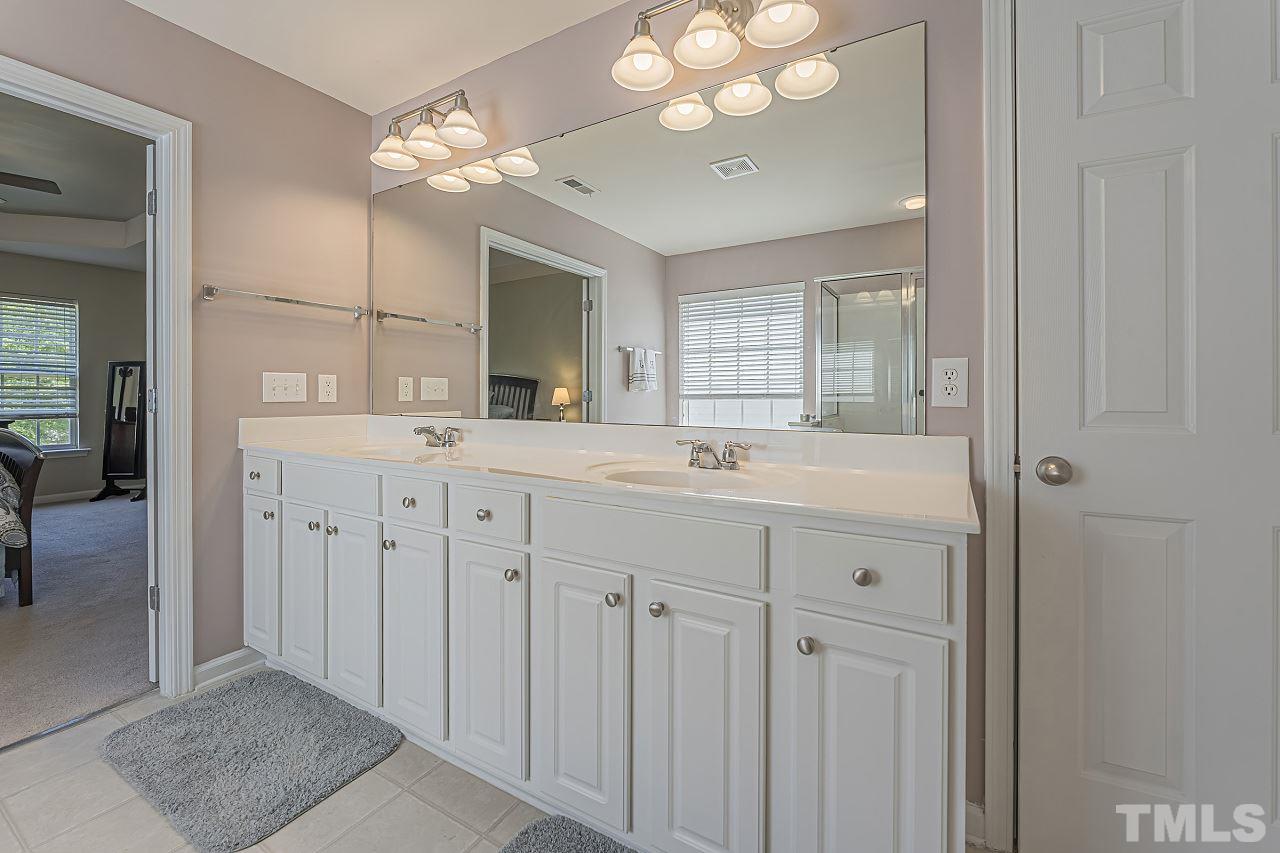 7759 San Gabriel Street Raleigh, NC 27613 - Photo 21 of 30 a bathroom with a sink vanity and a mirror