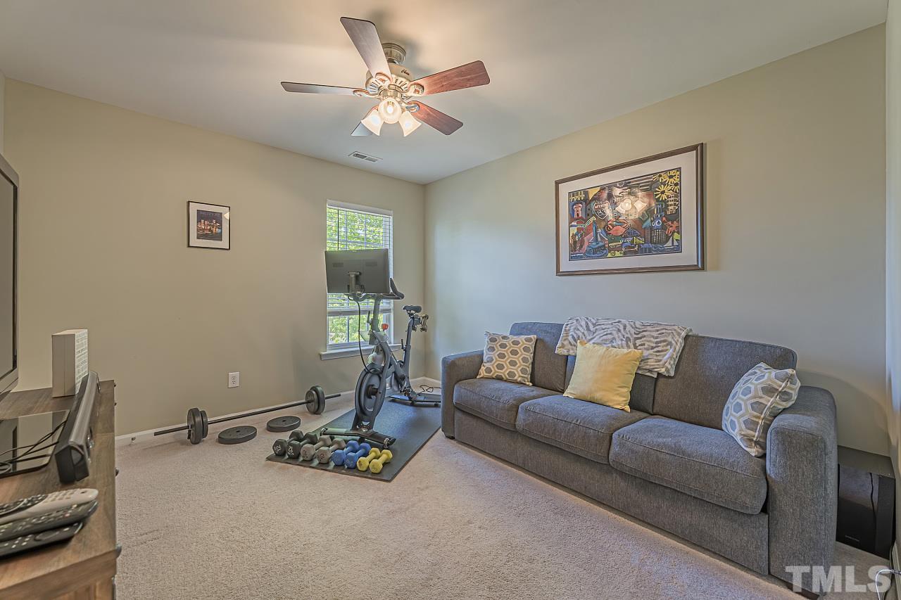 7759 San Gabriel Street Raleigh, NC 27613 - Photo 27 of 30 a living room with furniture and a chandelier
