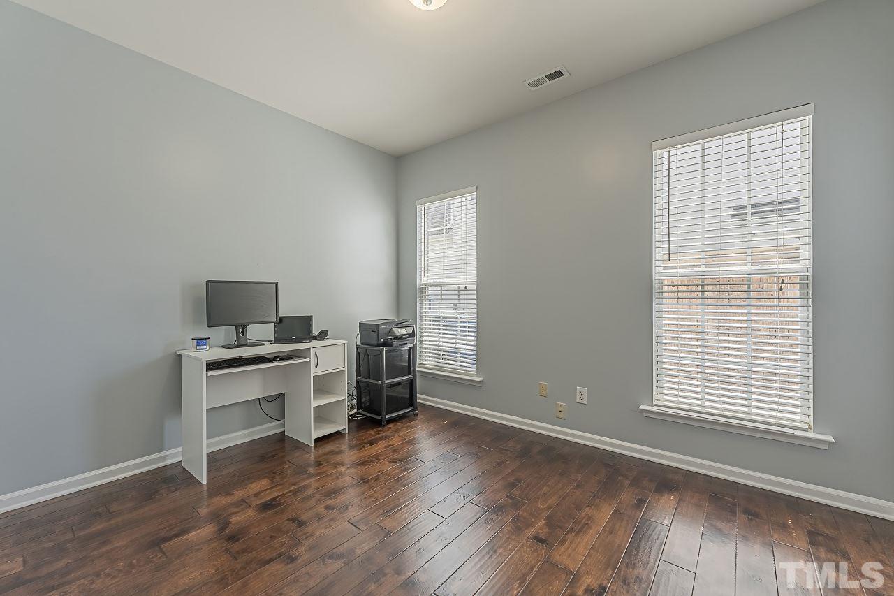 7759 San Gabriel Street Raleigh, NC 27613 - Photo 7 of 30 a workspace with furniture hardwood and a window