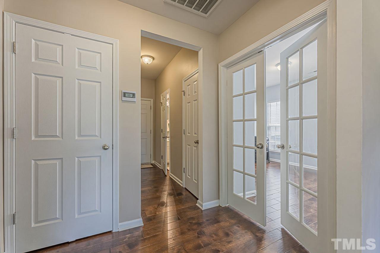 7759 San Gabriel Street Raleigh, NC 27613 - Photo 8 of 30 a view of a hallway with wooden floor and closet area