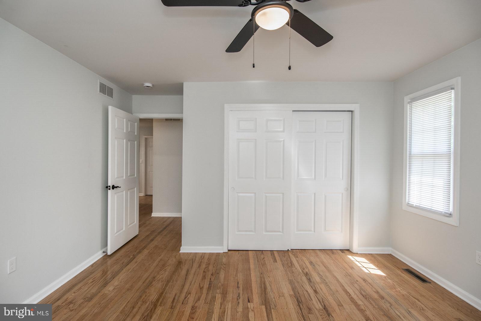558 Sentinel Road Moorestown, NJ 08057 - Photo 83 of 144 an empty room with wooden floor cabinet and windows