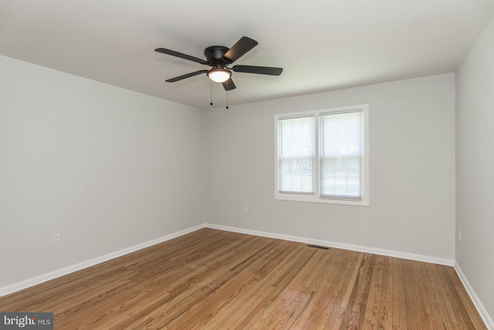 558 Sentinel Road Moorestown, NJ 08057 - Photo 94 of 144 an empty room with wooden floor fan and windows