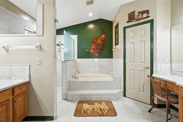 a bathroom with a tub and a shower