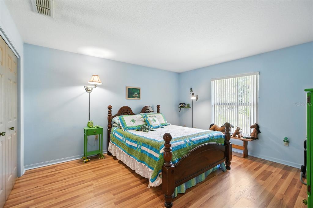 29933 Fullerville Road DeLand, FL 32720 - Photo 19 of 57 a bedroom with a bed and wooden floor