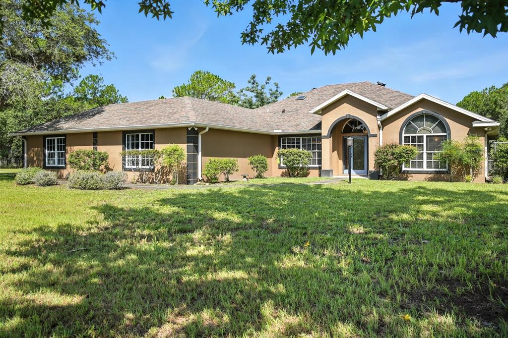 29933 Fullerville Road DeLand, FL 32720 - Photo 2 of 57 a front view of a house with a yard