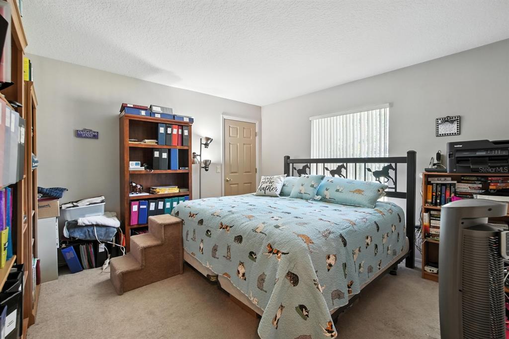 29933 Fullerville Road DeLand, FL 32720 - Photo 21 of 57 a bedroom with a bed and a book shelf